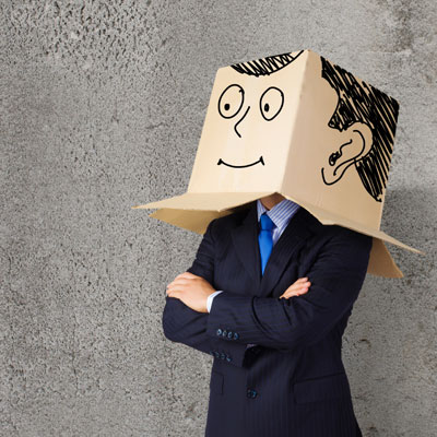 Man wearing a cardboard box on his head with a face drawn on to represent not being his true self